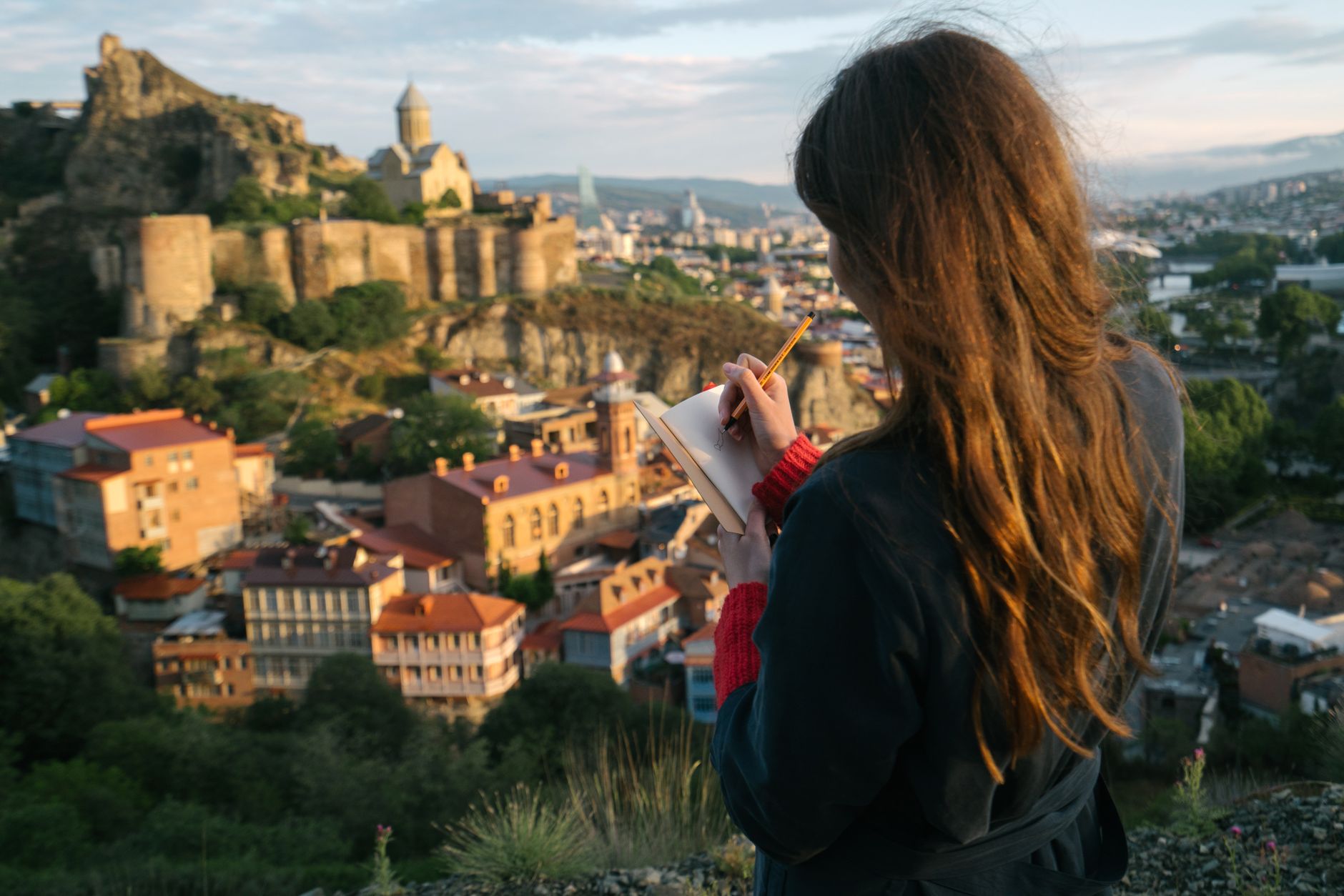 Travel journal editor taking field notes